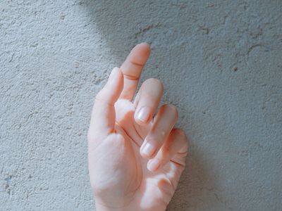 Close-up of a person's hands in a calm pose.